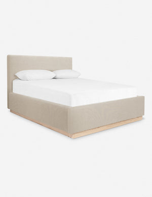 An angled side view of the Lockwood sand-striped velvet-upholstered bed with a white oak base.