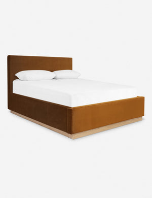 An angled side view of the Lockwood cognac velvet-upholstered bed with a white oak base.