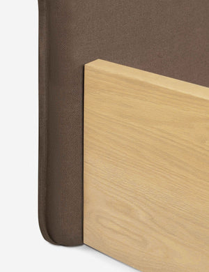 Where the headboard and wooden base connect on the Nia mushroom brown linen bed