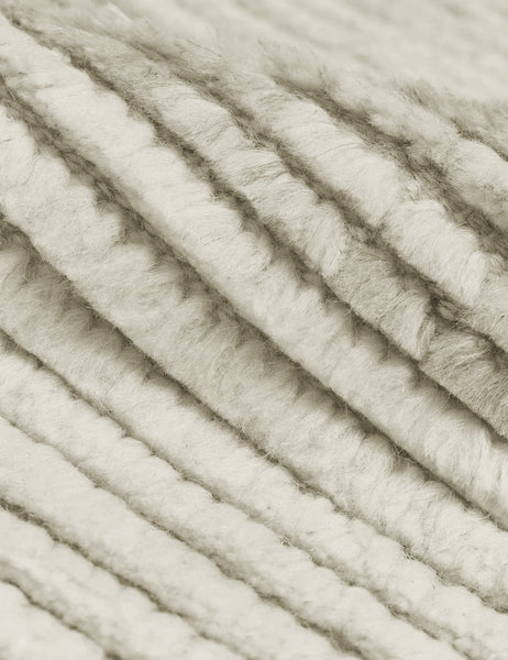 #size::2-6--x-8- #size::6--x-9- #size::8--x-10- #size::9--x-12- #size::10--x-14- #size::12--x-15- | Close-up of the two-toned ribbed fabric on the Nomad neutral-toned geometric floor rug by Élan Byrd