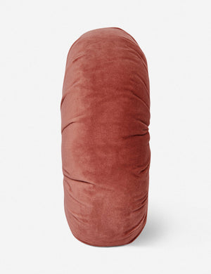 Side view of the Monroe coral pink velvet round pillow