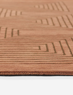 Angled close-up view of the edge and striped geometric pattern on the Simone brown tonal rug