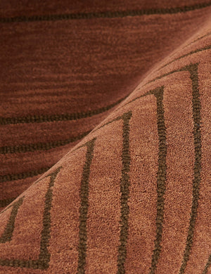 Close-up of the hand-tufted wood fabric and striped geometric pattern on the Simone brown tonal rug