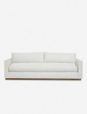 Walden white upholstered sofa with a wood plinth base and deep seats